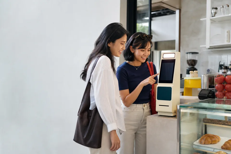 Two guests using Boothworks Receipt beside a cafe counter