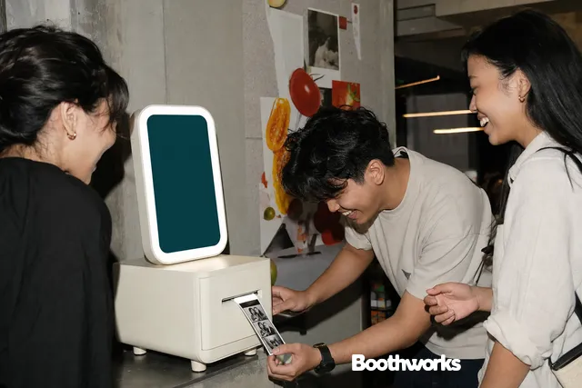 Friends collecting a thermal photo receipt